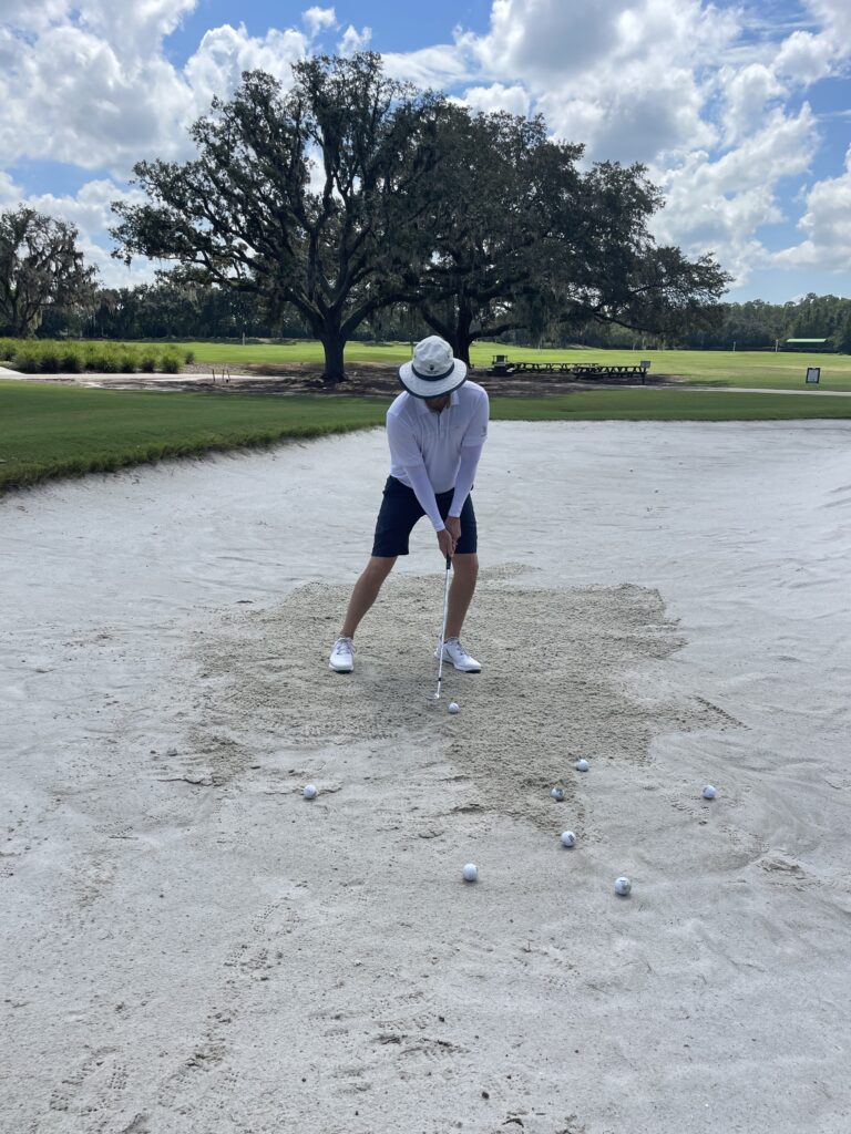 hitting a bunker shot with weight on the left side