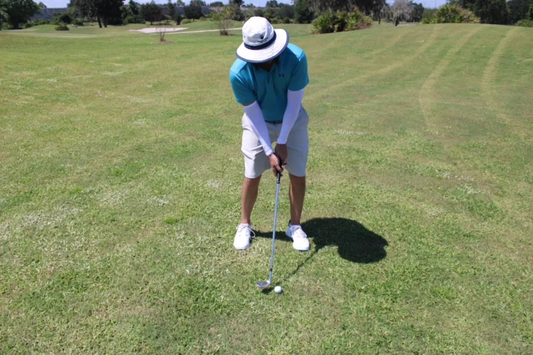 Golfer hitting a chip shot around the green in Orlando, FL